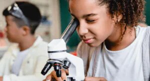 Student looking through microscope